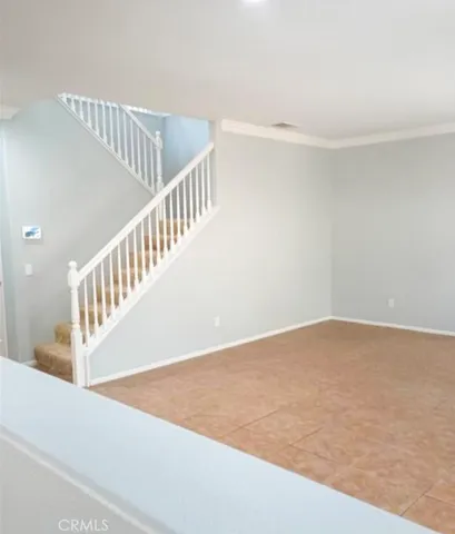 a view of a dry yard with wooden fence