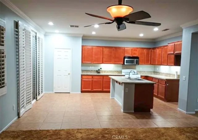 a kitchen with stainless steel appliances granite countertop a stove sink and cabinets
