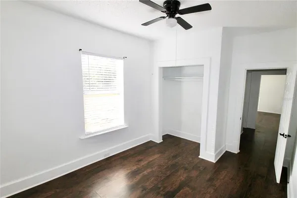 a view of a room with wooden floor and windows
