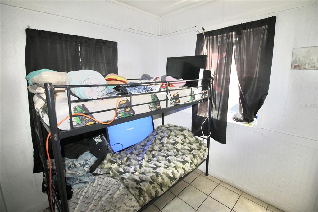 610 Dundee Road Dundee, FL 33838 - Photo 33 of 42 a bedroom with a bed and a dresser