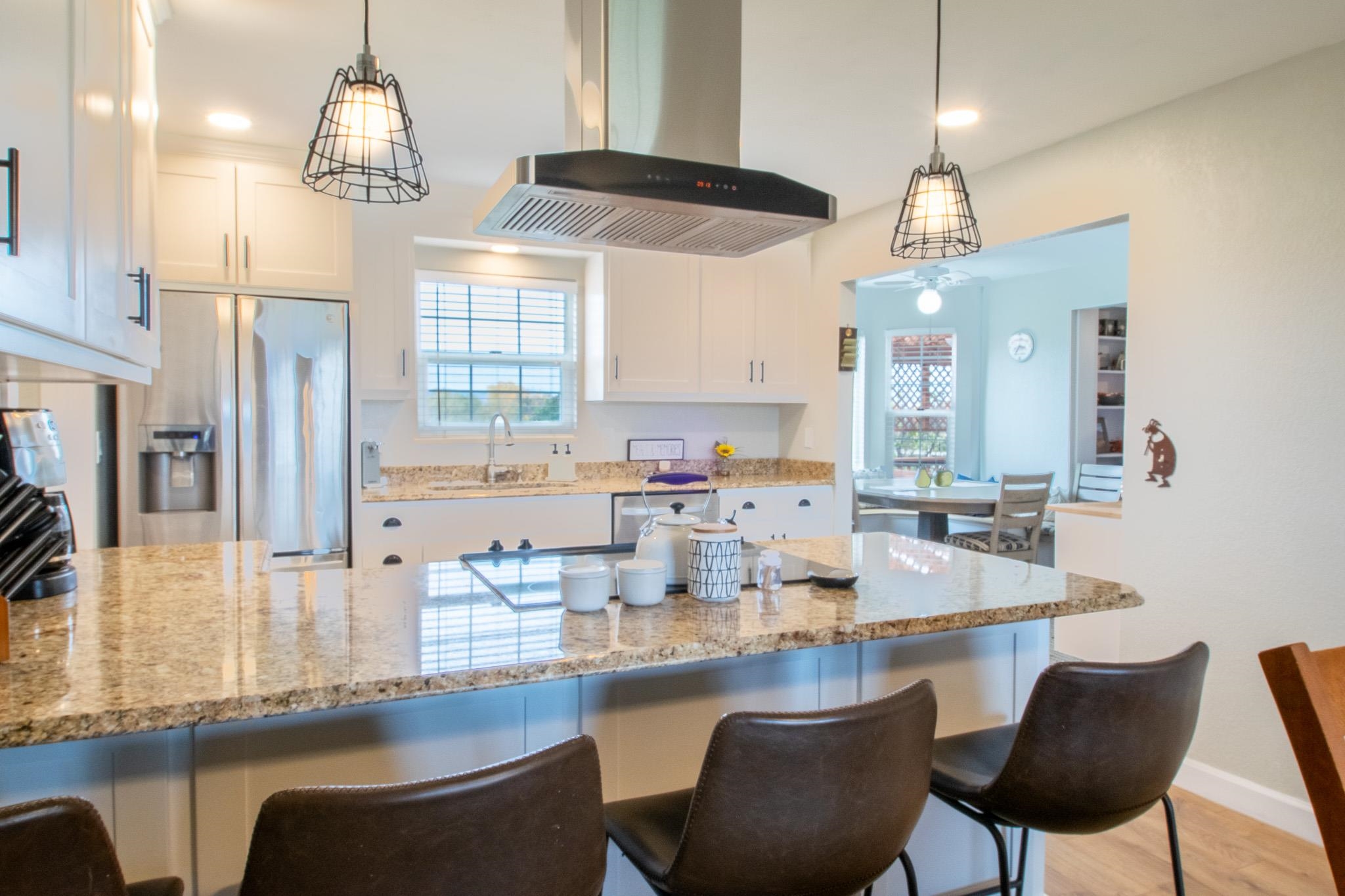 273 30 Road Grand Junction, CO 81503 - Photo 13 of 42 a kitchen with stainless steel appliances kitchen island granite countertop a table and chairs in it