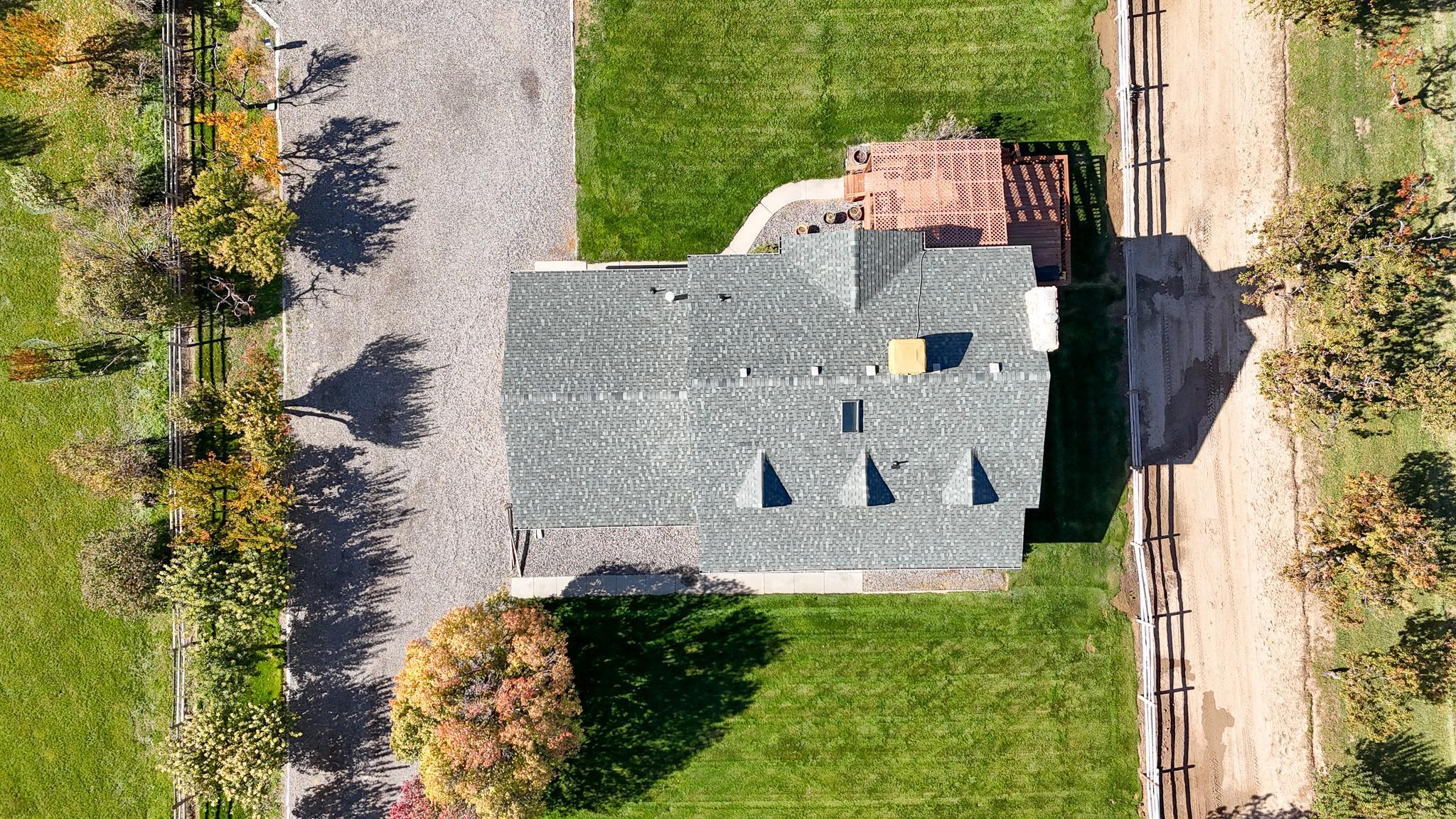 273 30 Road Grand Junction, CO 81503 - Photo 35 of 42 an aerial view of a house with a yard and trees all around