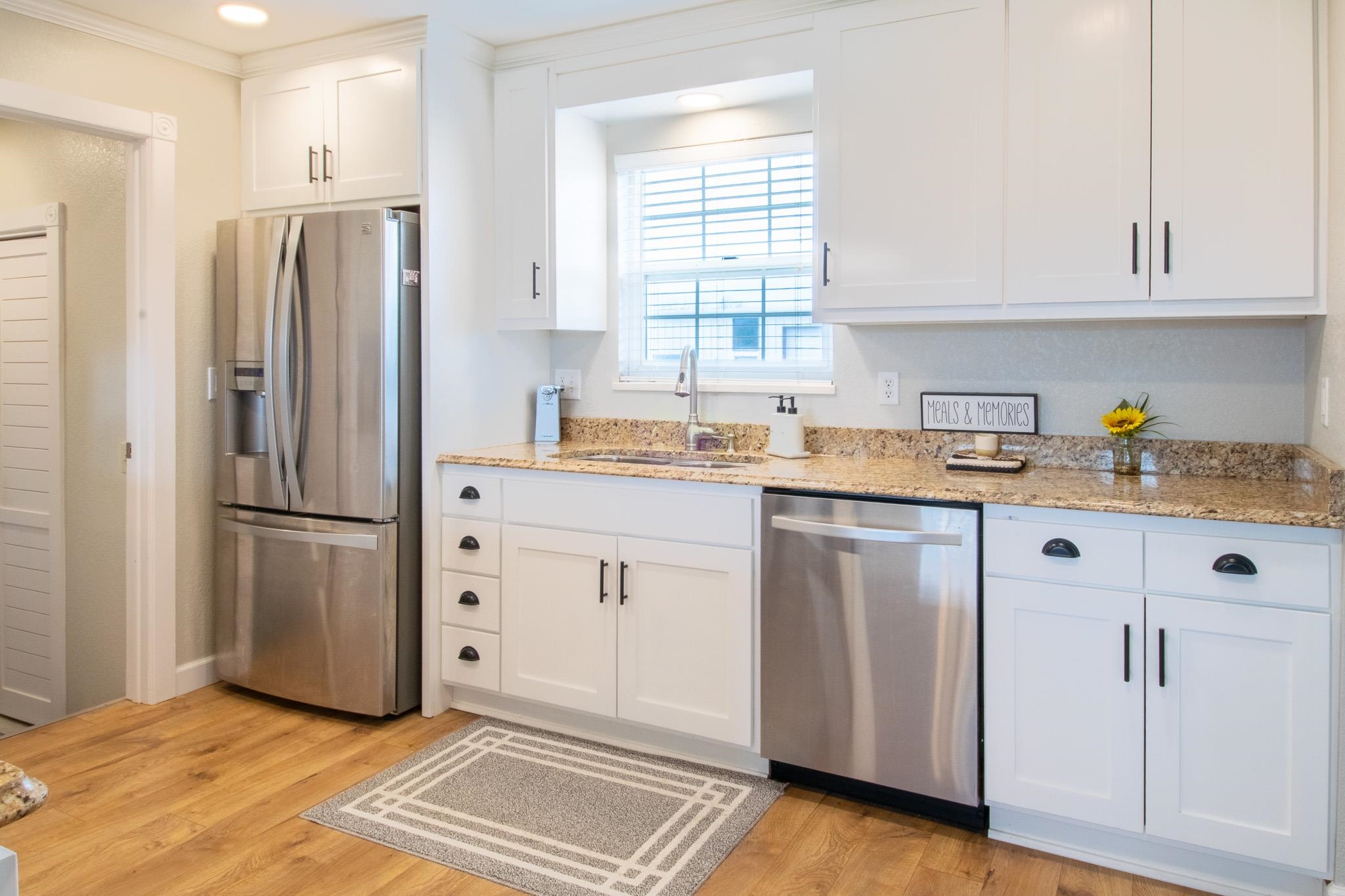 273 30 Road Grand Junction, CO 81503 - Photo 8 of 42 a kitchen with a refrigerator sink and cabinets