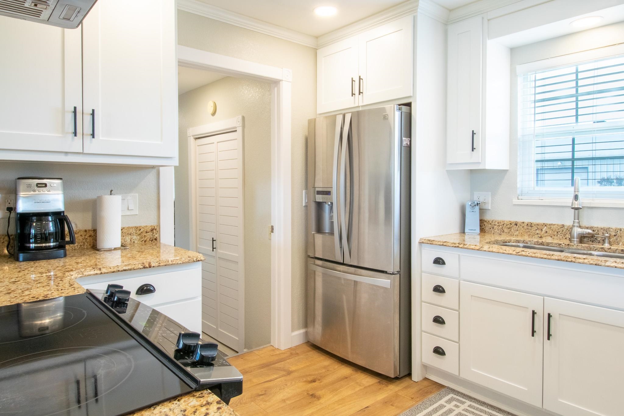 273 30 Road Grand Junction, CO 81503 - Photo 9 of 42 a kitchen with granite countertop a refrigerator and a sink