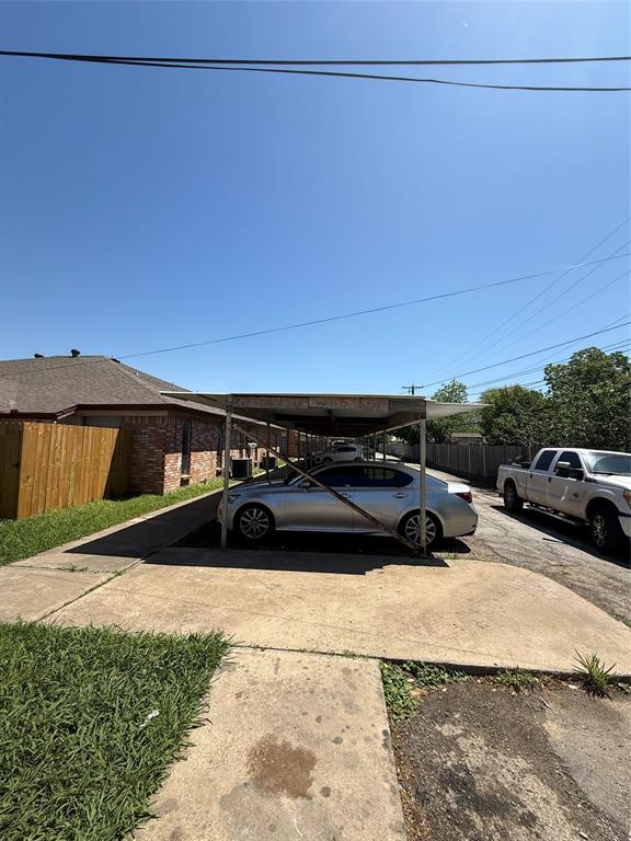 708 East Pecan Street, Unit 712 Hurst, TX 76053 - Photo 2 of 15 Covered carport parking structure with a metal frame
