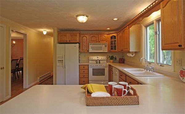 157 Kaleva Road Lancaster, MA 01523 - Photo 7 of 26 a kitchen with stainless steel appliances granite countertop a sink refrigerator and cabinets