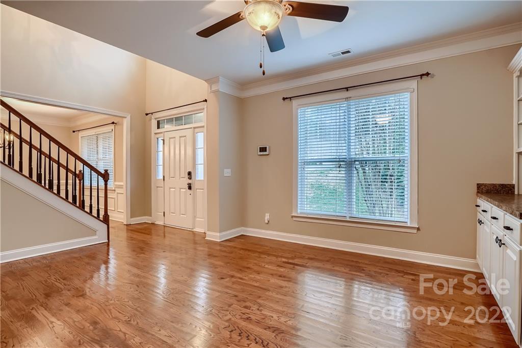 11114 Broken Brook Way Tega Cay, SC 29708 - Photo 15 of 33 a view of an empty room with wooden floor and a window