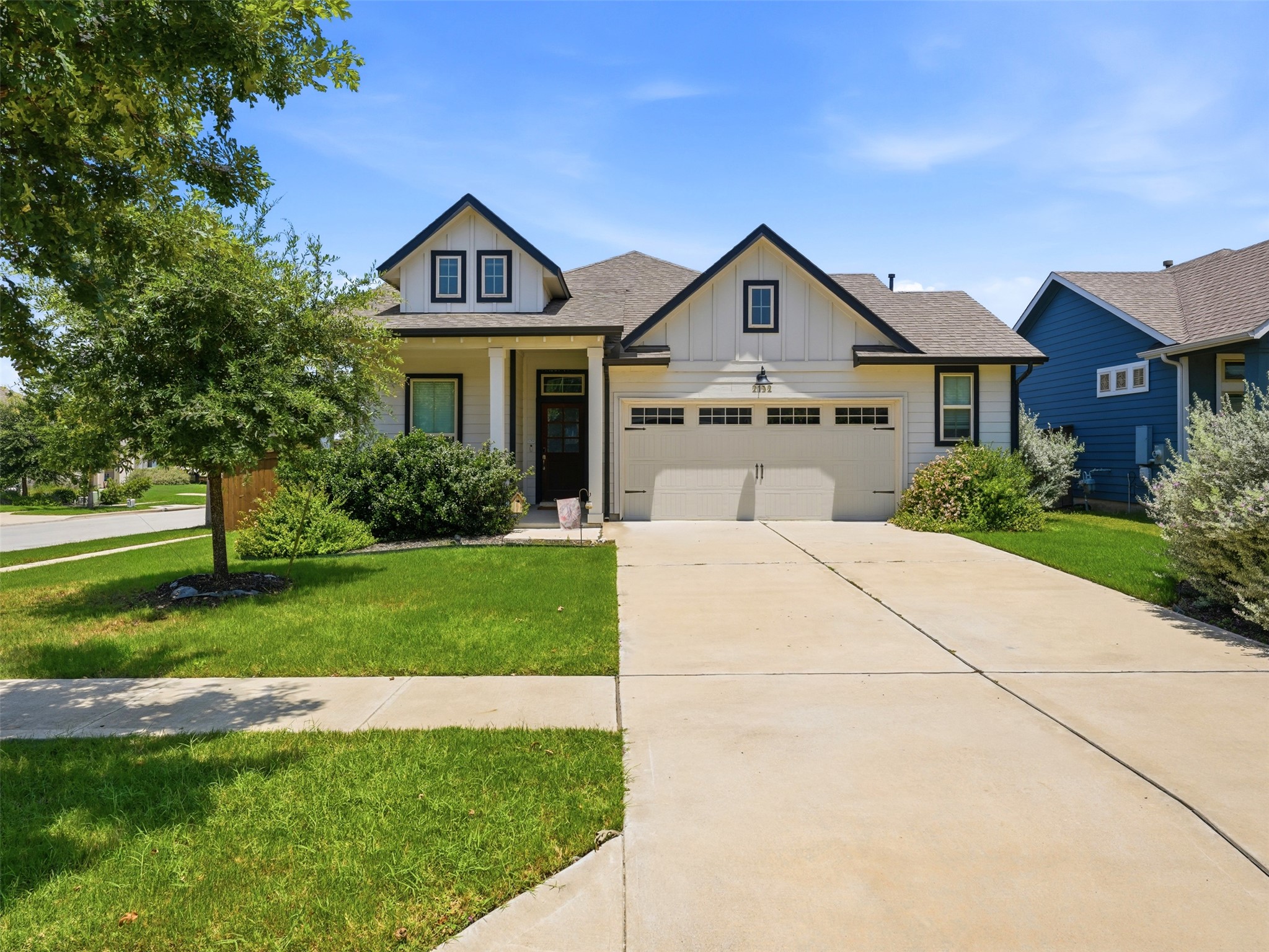 2132 Ringstaff Road Leander, TX 78641 - Photo 1 of 39 Well-maintained grounds frame this charming home with an attached garage and welcoming entryway.