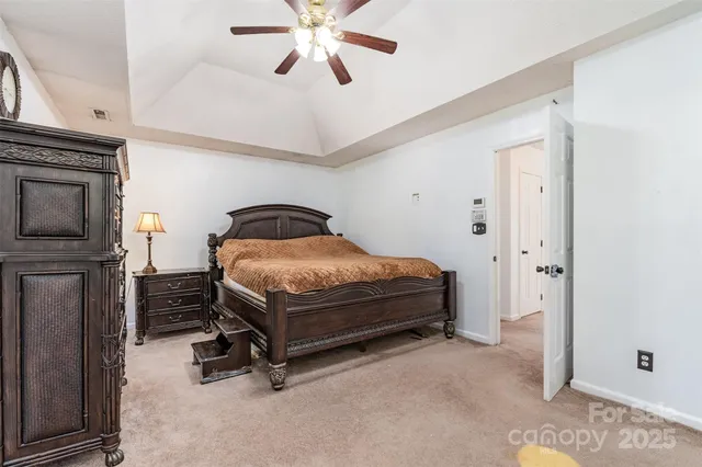 a bedroom with a bed and a ceiling fan