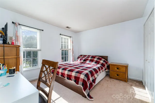 a bedroom with a bed a table and chair