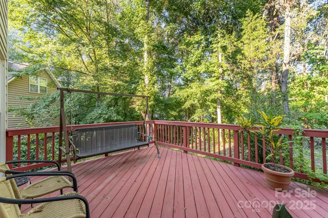 a view of a balcony with wooden floor and outdoor seating