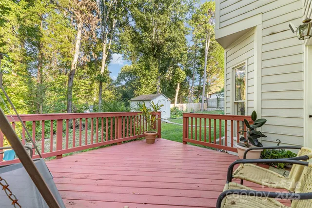 a view of balcony with wooden floor and fence