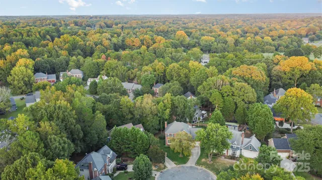 an aerial view of a house with yard