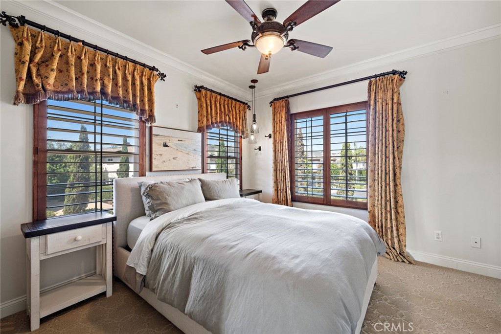 5 Via Monarca Street Dana Point, CA 92629 - Photo 28 of 64 a bedroom with a large bed and a chandelier fan