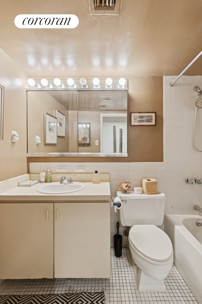 253 West 73rd Street, Unit 7L Manhattan, NY 10023 - Photo 4 of 5 a bathroom with a sink a toilet and mirror
