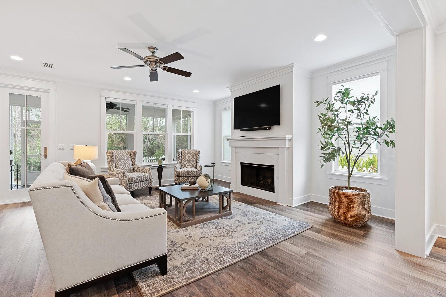 51 Sandchase Circle Watersound, FL 32461 - Photo 11 of 24 a living room with furniture a fireplace and a flat screen tv