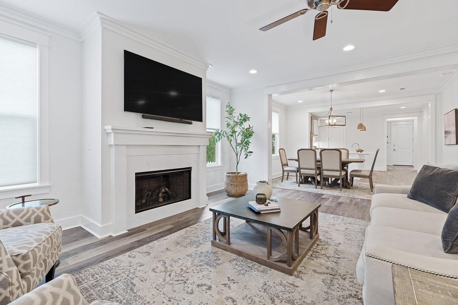 51 Sandchase Circle Watersound, FL 32461 - Photo 12 of 24 a living room with furniture a flat screen tv and a fireplace