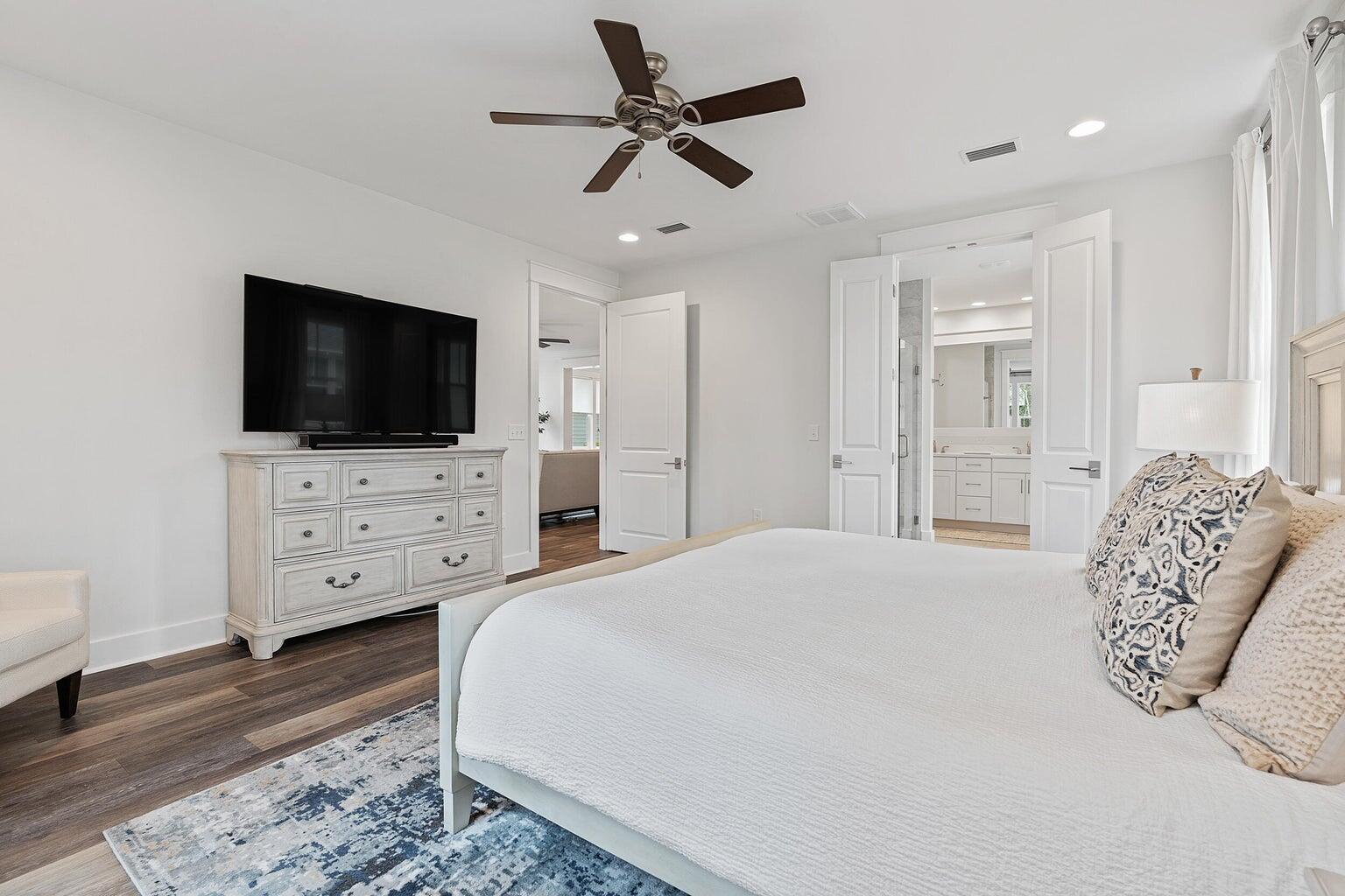 51 Sandchase Circle Watersound, FL 32461 - Photo 14 of 24 a spacious bedroom with a bed and a flat screen tv