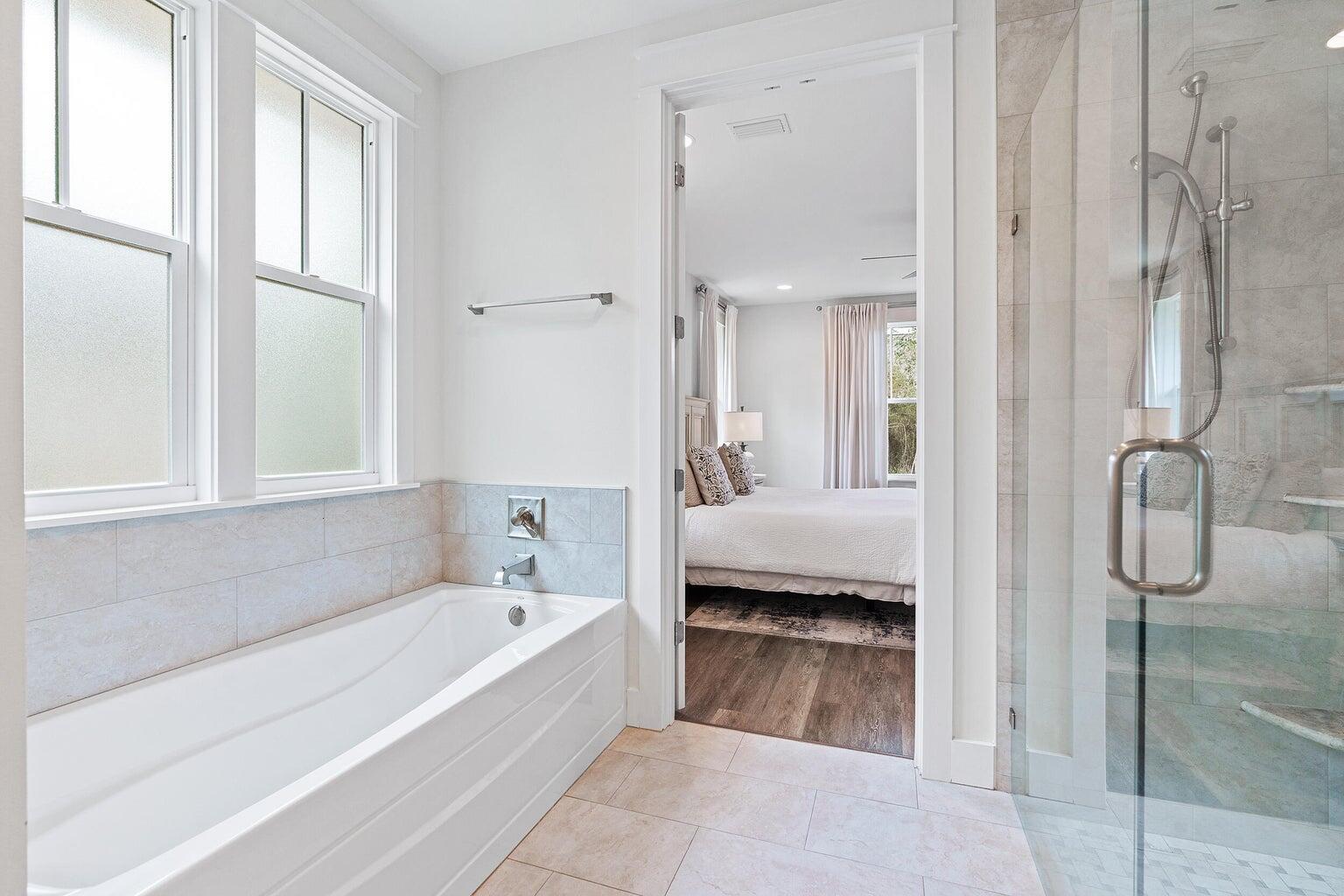 51 Sandchase Circle Watersound, FL 32461 - Photo 17 of 24 a en suite bathroom with a tub shower and window