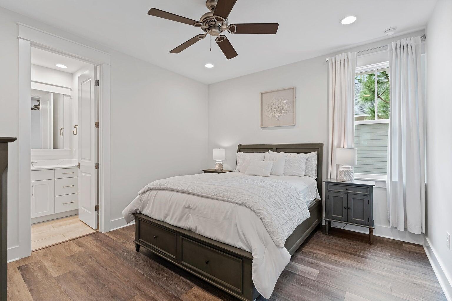 51 Sandchase Circle Watersound, FL 32461 - Photo 18 of 24 a bedroom with a bed and a chandelier