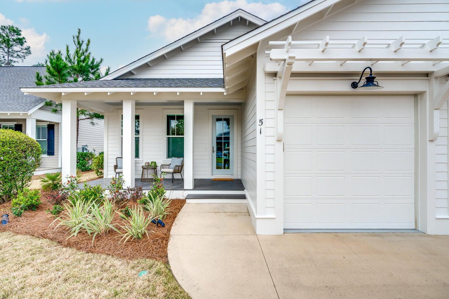 51 Sandchase Circle Watersound, FL 32461 - Photo 2 of 24 a front view of a house with garden