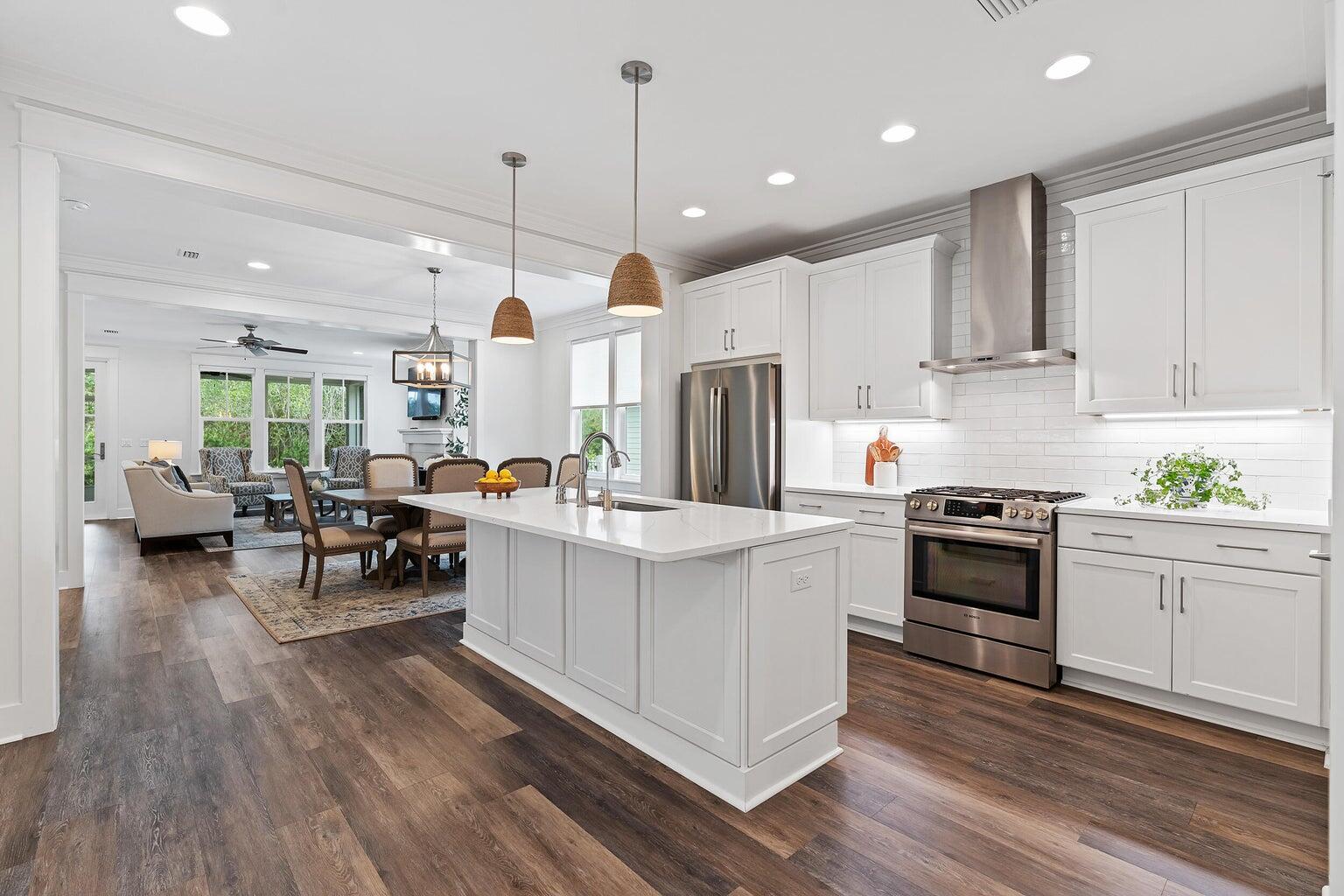 51 Sandchase Circle Watersound, FL 32461 - Photo 7 of 24 a kitchen with white cabinets and stainless steel appliances