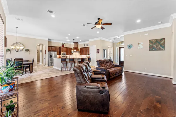 a living room with furniture and a wooden floor