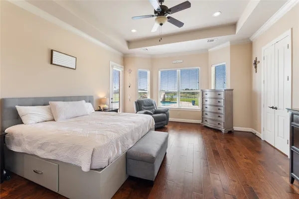 a bedroom with a bed and a chandelier