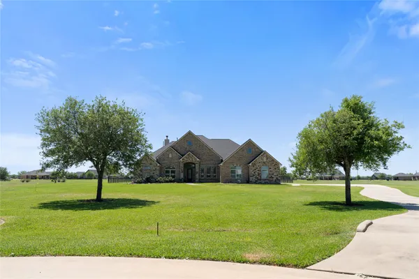 a view of a hallway with wooden floor and furniture