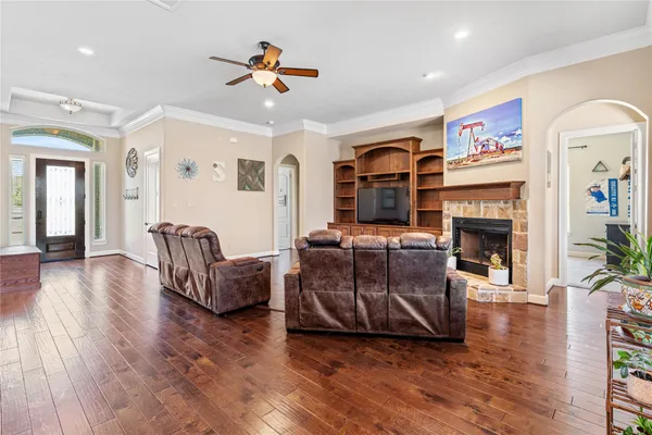a view of a dining room and livingroom with furniture a rug a chandelier and kitchen view