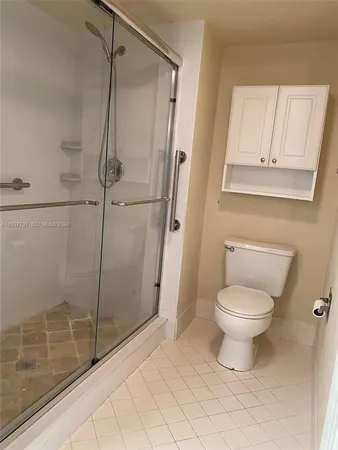 a bathroom with a toilet and a shower
