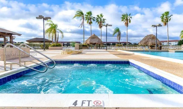 a view of sign board with flower plants