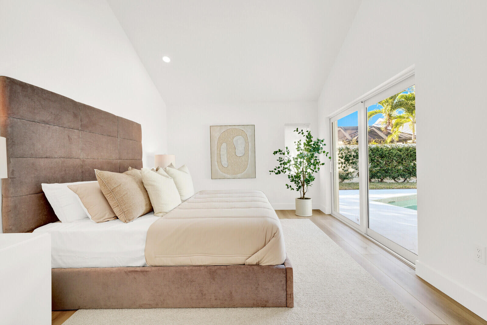 418 River Edge Road Jupiter, FL 33477 - Photo 19 of 44 a bedroom with a large bed and a potted plant