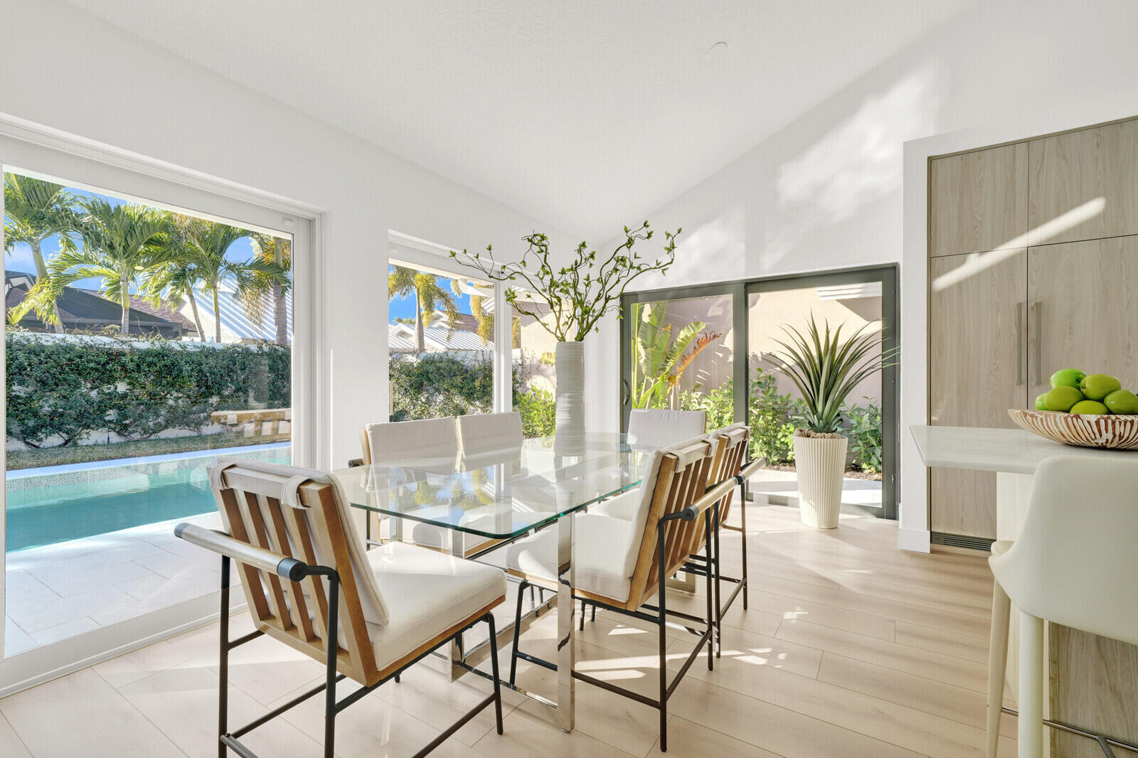 418 River Edge Road Jupiter, FL 33477 - Photo 5 of 44 a view of a dining room with furniture large windows and wooden floor
