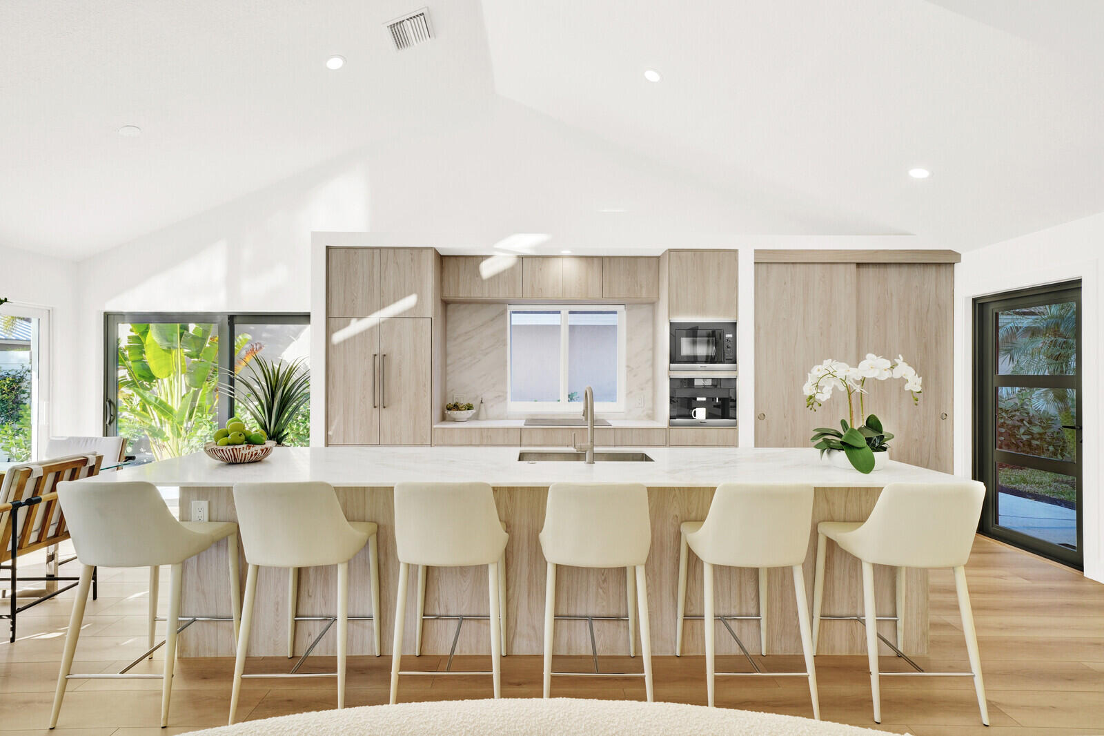 418 River Edge Road Jupiter, FL 33477 - Photo 10 of 44 a kitchen with a dining table chairs and stove