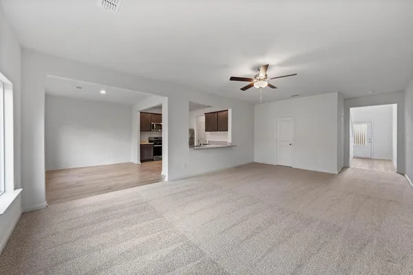 a view of an empty room with a ceiling fan