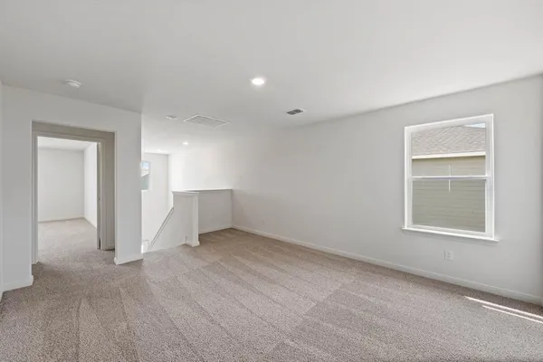 an empty room with windows and closet