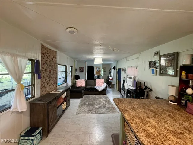 a living room with furniture rug and wooden floor