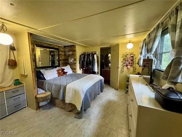 a bed room with a bed and a chair