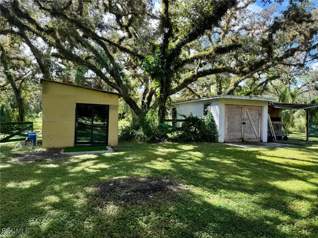 a view of a house with a yard and garage