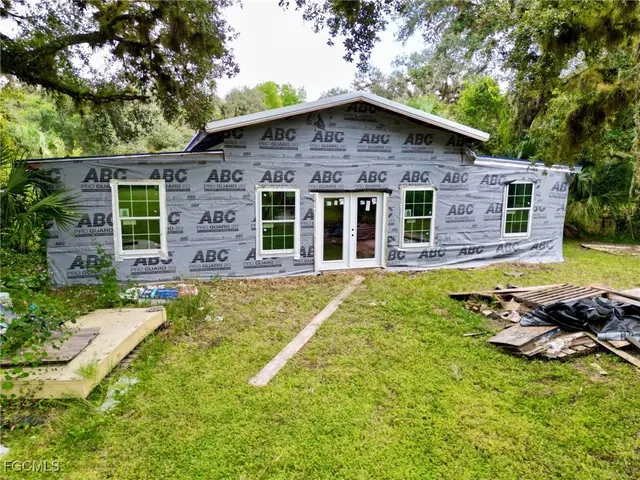 a house with swimming pool in front of it