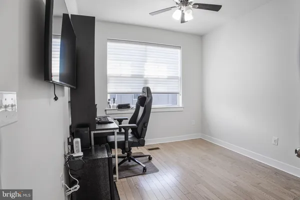 a view of a workspace with furniture and a window