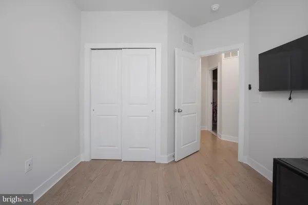 a bedroom with a bed and closet