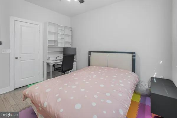 a bedroom with a bed window and a desk