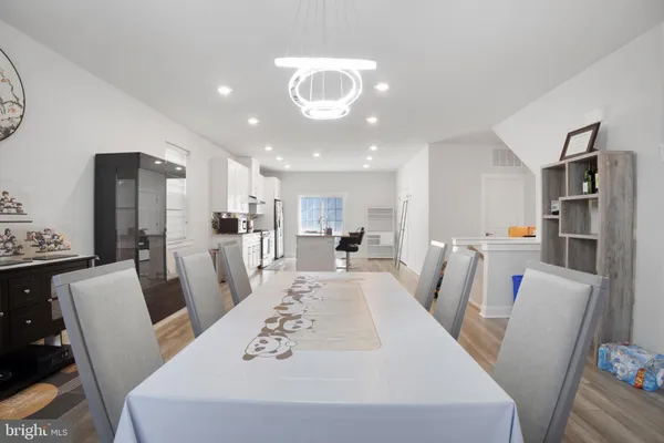 a kitchen with stainless steel appliances granite countertop a stove a sink and white cabinets