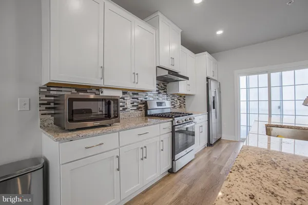 a kitchen with sink cabinets and wooden floor