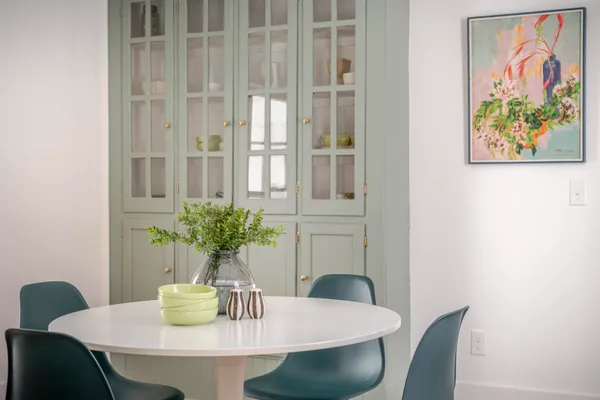 a dining room with furniture and wooden floor
