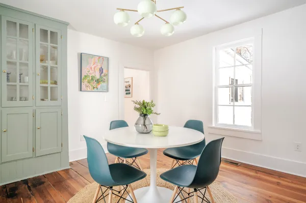 a view of a dining room with furniture window and wooden floor