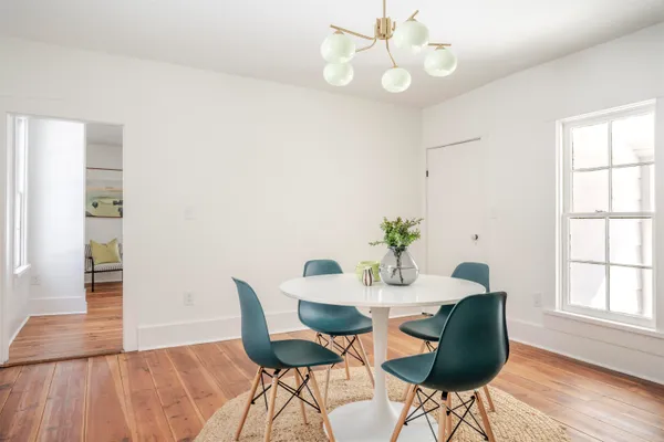 a view of a dining room with furniture wooden floor and chandelier