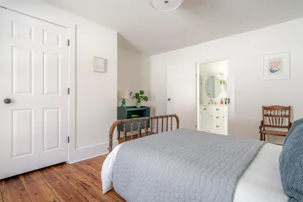 a bedroom with a bed and a table
